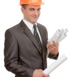 Smiling engineer in hardhat with plans isolated on white